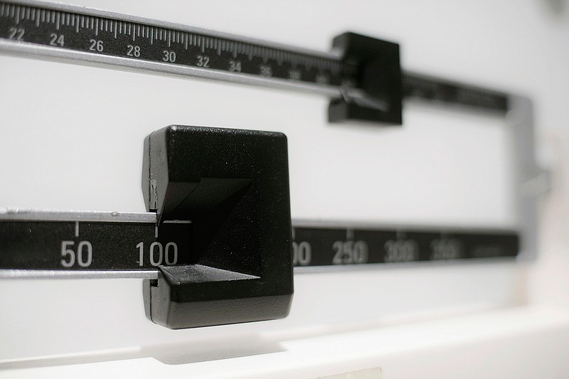This April 3, 2018, file photo shows a closeup of a beam scale in New York. A study released on Tuesday, June 18, 2019, found U.S. preschoolers on government food aid have grown a little less pudgy, offering fresh evidence that previous signs of shrinking obesity weren't a fluke. Obesity rates dropped to about 14 percent in 2016, the latest data available and a steady decline from 16 percent in 2010, researchers from the federal Centers for Disease Control and Prevention reported.  (AP Photo/Patrick Sison, File)