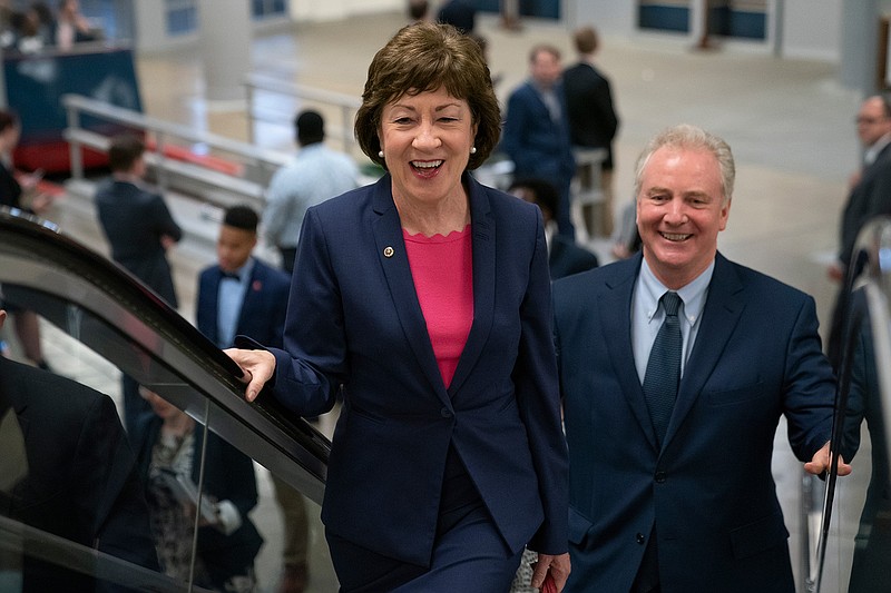 Republican Sen. Susan Collins of Maine, joined by Sen. Tim Kaine, D-Va., right, arrives at the Capitol to extend her perfect Senate voting record to 7,000, as she prepares for a 2020 campaign , in Washington, Tuesday, June 18, 2019. (AP Photo/J. Scott Applewhite)