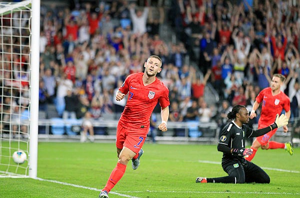 Paul Arriola of the United States runs after scoring past Guyana goalie Akel Clarke during the first half of a CONCACAF Gold Cup match Tuesday night in St. Paul, Minn.