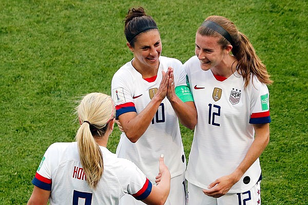 Carli Lloyd (center) celebrates with U.S. teammates Lindsey Horan and Tierna Davidson after scoring the opening goal during Sunday's match against Chile in the Women's World Cup at the Parc des Princes in Paris.