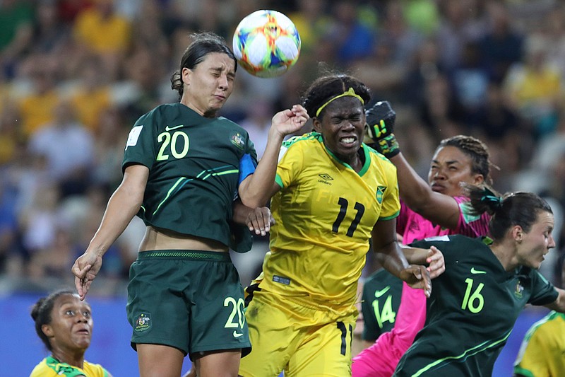 Australia's Sam Kerr, top left, jumps for the ball with Jamaica's Khadija Shaw, center, during the Women's World Cup Group C soccer match between Jamaica and Australia at Stade des Alpes stadium in Grenoble, France, Tuesday, June 18, 2019. (AP Photo/Laurent Cipriani)