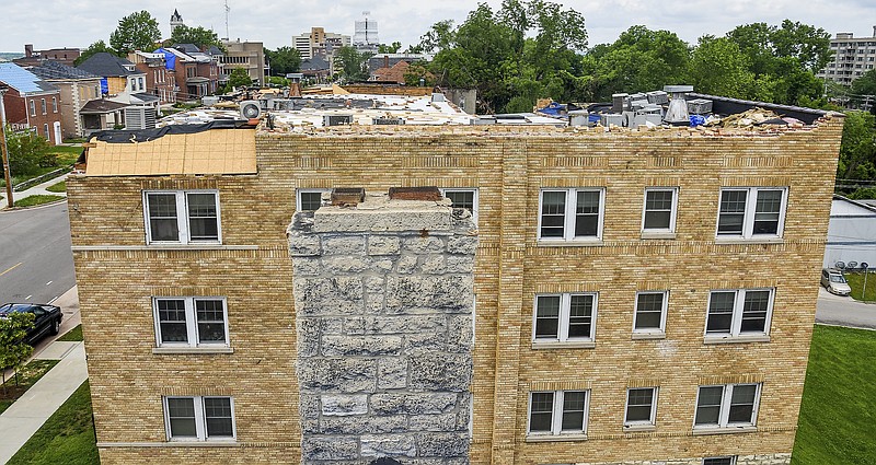 News Tribune fileThe chimney in the foreground is atop the Bella Vista Apartments, of 611 E. Capitol Ave, pictured on June 20. The building still stands but not without having suffered major damage during the tornado of May 22. Building owner Steve Laux is working to reopen the apartments as quickly as possible.