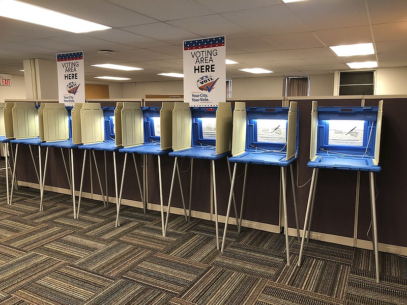 In this Sept. 20, 2018 photo, voting booths stand ready in downtown Minneapolis for the opening of early voting in Minnesota. A majority of Americans are concerned that a foreign government might interfere in some way in the 2020 presidential election, whether by tampering with election results, stealing information or by influencing candidates or voter opinion, a new poll shows.(AP Photo/Steve Karnowski)