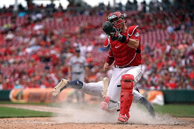 Houston Astros' Tony Kemp, back, is tagged out at home plate as he collides with Cincinnati Reds' Curt Casali in the eighth inning of a baseball game, Wednesday, June 19, 2019, in Cincinnati. The Reds won 3-2. (AP Photo/Aaron Doster)
