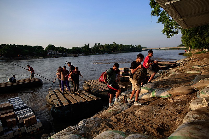 A group of migrants arriving from Guatemala disembark from a raft in Ciudad Hidalgo, Mexico, Tuesday, June 18, 2019. The number of migrants taking rafts at the busy Ciudad Hidalgo crossing point appears to have decreased significantly in recent days amid fears of a pending deployment of the National Guard along the southern border. (AP Photo/Rebecca Blackwell)
