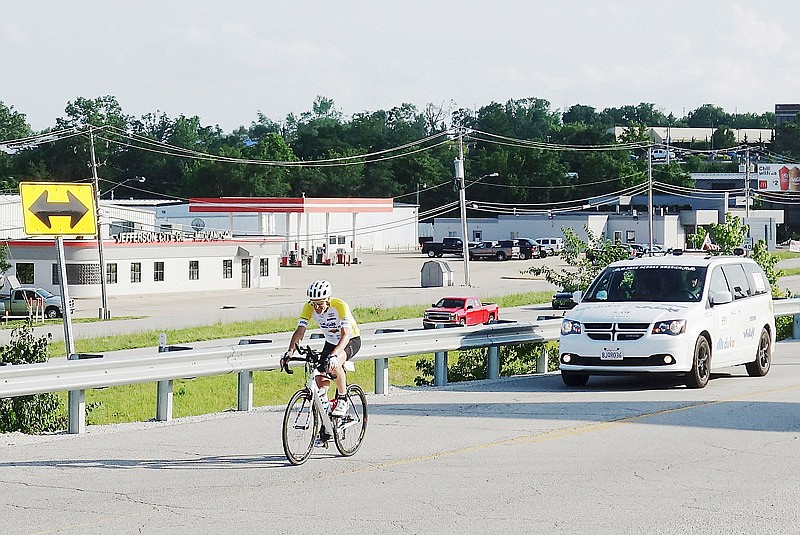 Followed by his support team, Italian bicyclist Martin Bergmeister prepares to make a pit stop Wednesday, June 19, 2019, at the Jefferson City checkpoint for Race Across America. Cyclists stopped at a tent on the lot of Jefferson Street Conoco to mark their time and location before either resting or continuing. Bicyclists will be passing through in coming days as they traverse the country, having begun in California and ending in Maryland.