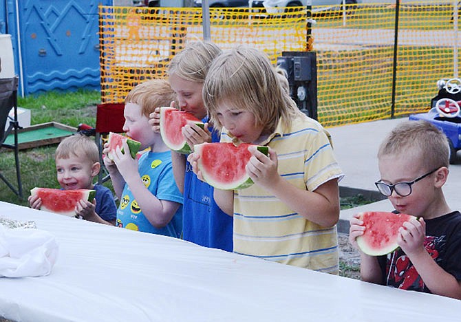 Children rush to take their first bite of watermelon during the watermelon eating contest at the annual Tebbetts Comunity Picnic in 2018. Each child recieved a prize after finishing.