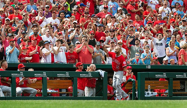 Albert Pujols of the Angels waves to fans after getting a curtain call after he hit a home run during seventh inning of Saturday afternoon's game against the Cardinals at Busch Stadium.