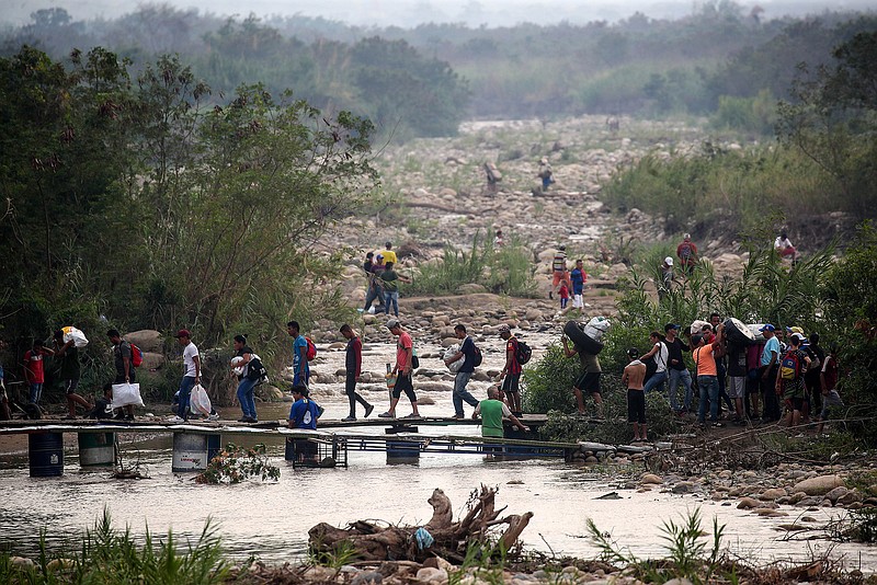 Locals illegally cross the Venezuelan-Colombian border at Simon Bolivar International Bridge on March 11, 2019. On that day, Venezuela partially opened the border with Colombia for school and university students needing medical care and people accompanying them. (Valery Sharifulin/TASS/Abaca Press/TNS) 