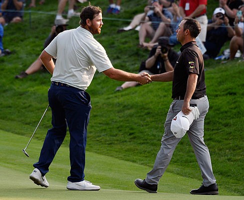 Zack Sucher (left) shakes hands with Chez Reavie after they finished Saturday's third round of the Travelers Championship in Cromwell, Conn.
