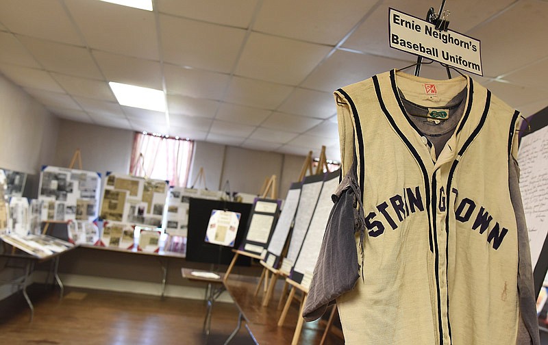 This uniform from an amateur baseball team in nearby Stringtown is hung in June 2018 for public display at the Lohman Community Center, the result of several volunteers' efforts to promote the history of their community by gathering, compiling, organizing, categorizing and mounting various historical records and items.