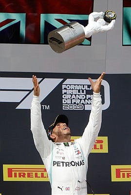 Lewis Hamilton celebrates on the podium Sunday after winning the French Formula One Grand Prix at the Paul Ricard racetrack in Le Castellet, southern France.