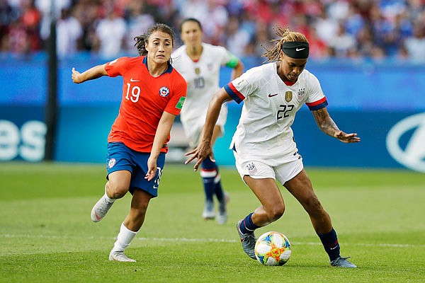 Jessica McDonald of the United States dribbles while Chile's Yessenia Huenteo tries to defend during a match last Sunday in Paris.