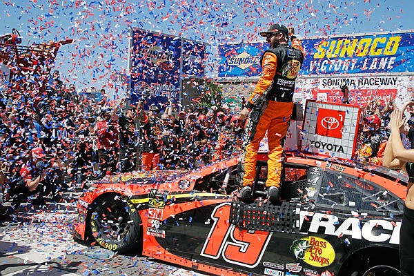 Martin Truex Jr. celebrates after winning Sunday afternoon's NASCAR Sprint Cup Series race in Sonoma, Calif.