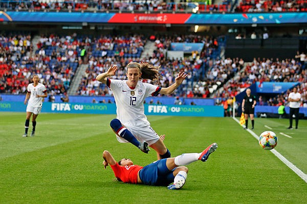 Tierna Davidson of the United States (top) vies for the ball with Chile's Elisa Duran last Sunday during a Women's World Cup Group F match at Parc des Princes in Paris.