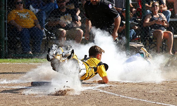 St. Elizabeth catcher Coltin Green makes a tag at the plate during the Class 1 quarterfinal game against Wellsville in St. Elizabeth. Green was a first-team all-state selection.