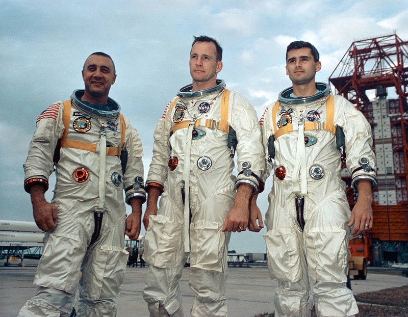 Astronauts, from the left, Gus Grissom, Ed White II and Roger Chaffee stand near Cape Kennedy's Launch Complex 34 during training for Apollo 1 in January 1967. On Jan. 27, 1967, the three astronauts were preparing for what was to be the first manned Apollo flight. The astronauts were sitting atop the launch pad for a pre-launch test when a fire broke out in their Apollo capsule. The investigation into the fatal accident led to major design and engineering changes, making the Apollo spacecraft safer for the coming journeys to the moon. (NASA/TNS)