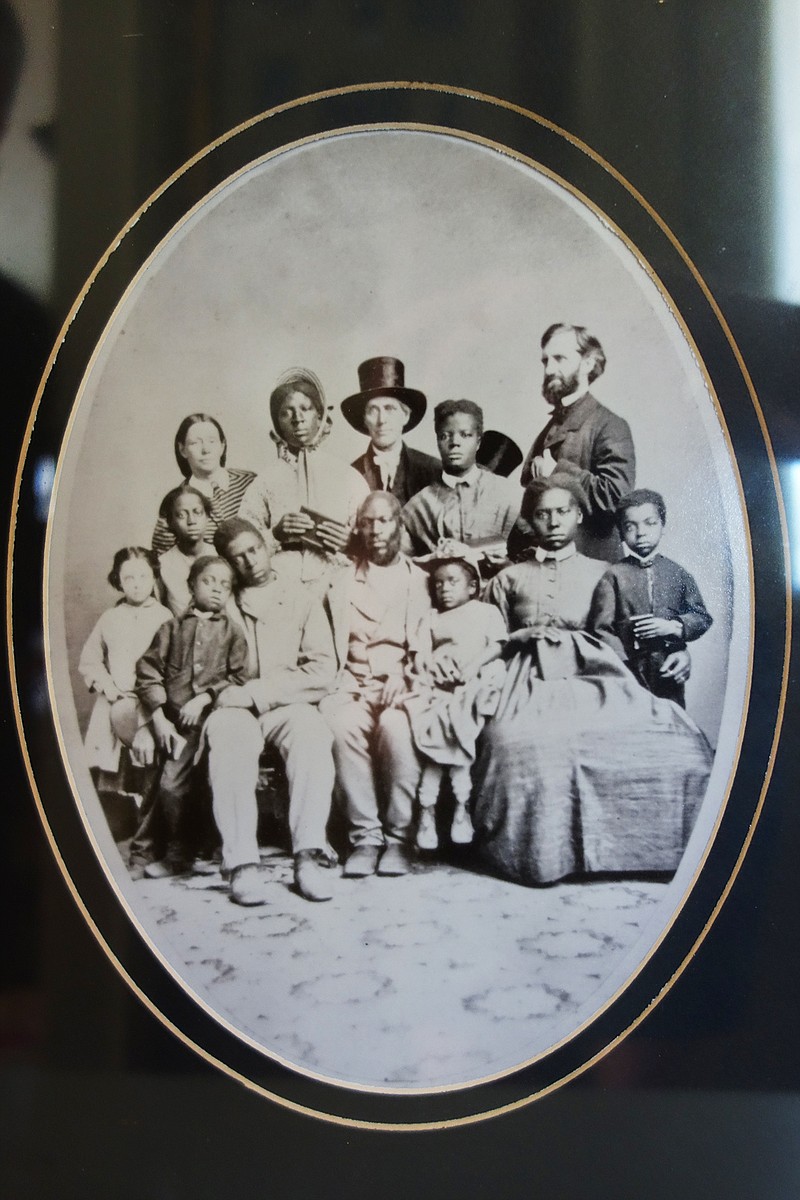 <p>Helen Wilbers/For the News Tribune </p><p>Abolitionist Levi Coffin, center, and Sylvia Rummel’s ancestor Jonathan Cable, right, pose with a family of escaped slaves en route along the Underground Railroad. The only other known original print of this portrait recently sold at auction for $81,250.</p>