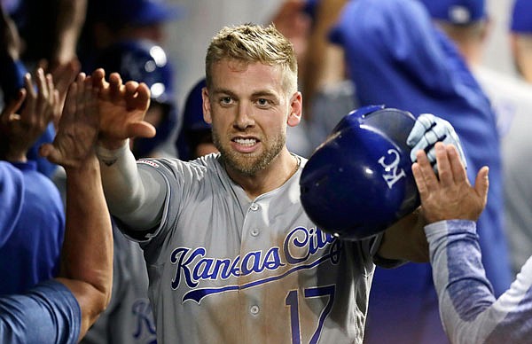 Hunter Dozier is congratulated by his Royals teammates after hitting a grand slam in the ninth inning of Tuesday night's game against the Indians in Cleveland.