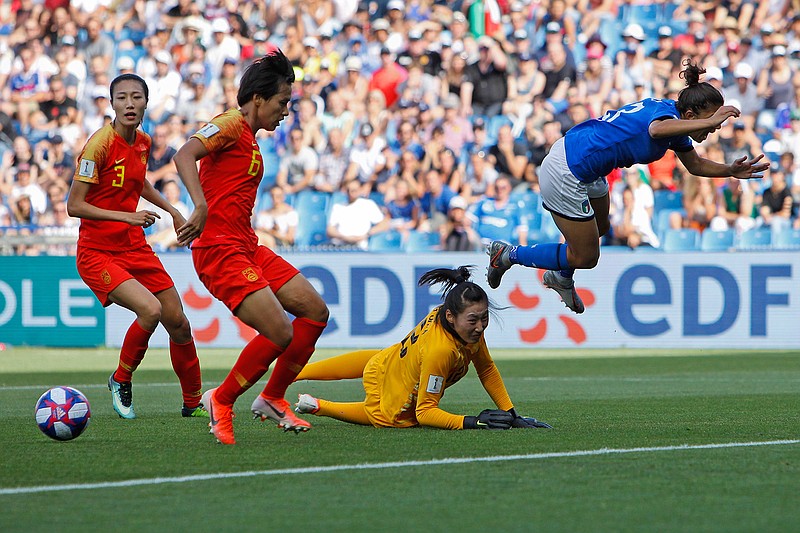 Italy's Elisa Bartoli, right, jumps over China goalkeeper Peng Shimeng, second right, just before Italy's Valentina Giacinti scored the opening goal during the Women's World Cup round of 16 soccer match between Italy and China at Stade de la Mosson in Montpellier, France, Tuesday, June 25, 2019. Italy won 2-0. (AP Photo/Claude Paris)