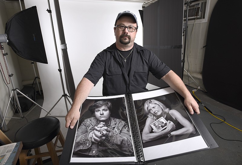 In this June 21, 2019, photo, Paul Gillespie, a photojournalist at the Capital Gazette newspaper, where five people were killed in a mass shooting in June 2018, holds a book of portraits he photographed of survivors and family members of those killed in the attack, at his home studio in Brooklyn Park, Md. It’s called: “Journalists Matter: Faces of the Capital Gazette.”  (AP Photo/Steve Ruark)