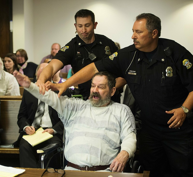 FILE - In this Nov. 10, 2015, file photo, Frazier Glenn Miller Jr., convicted of capital murder, attempted murder and other charges, gestures as Johnson County deputies remove Miller from the courtroom during the sentencing phase of his trial at the Johnson County District Court in Olathe, Kan. A recent Kansas Supreme Court ruling declaring that the state constitution protects access to abortion has opened the door to a new legal attack on the death penalty. Attorneys for five of the 10 men on death row in Kansas, including Miller Jr., argue that the abortion decision means the state's courts can enforce the broad guarantees of "life, liberty and the pursuit of happiness" in the Bill of Rights in the Kansas Constitution.   (Joe Ledford/The Kansas City Star via AP, Pool, File)
