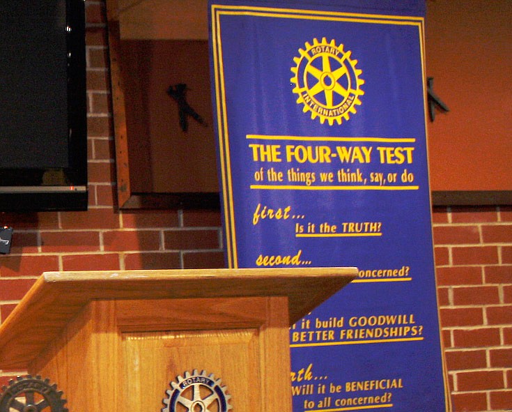 A Rotary banner hangs behind the podium during a Fulton Rotary Club meeting.