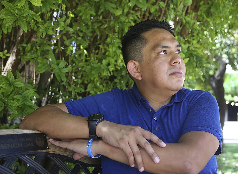 In this Friday, June 7, 2019 photo, Loren McCabe, who has had several Navajo family members afflicted by cancer and several have died from cancer, pauses while talking about the travel they had to take for treatment, while posing for a photo in Phoenix. The Tuba City Regional Health Care Corp. hospital on the Navajo Nation has begun offering cancer treatment to patients who previously had to travel long distances for care, and is the first treatment center of its kind on a Native American reservation. (AP Photo/Ross D. Franklin)