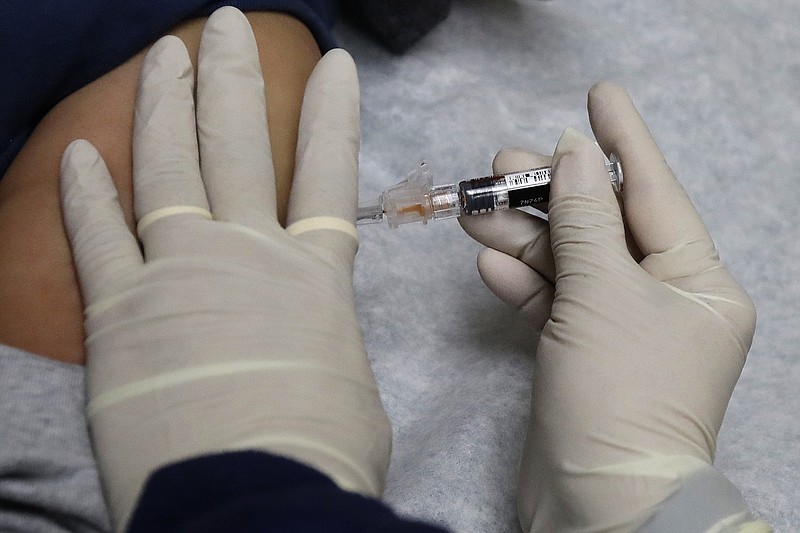 FILE - In this Jan. 12, 2018, file photo, a medical assistant at a community health center gives a patient a flu shot in Seattle. U.S. health officials say the flu vaccine has again turned out to be a disappointment. The vaccine didn’t work against a flu bug that popped up halfway through the season. Figures released Thursday, June 27, 2019,  show the vaccine was only 29% effective overall.   (AP Photo/Ted S. Warren, File)