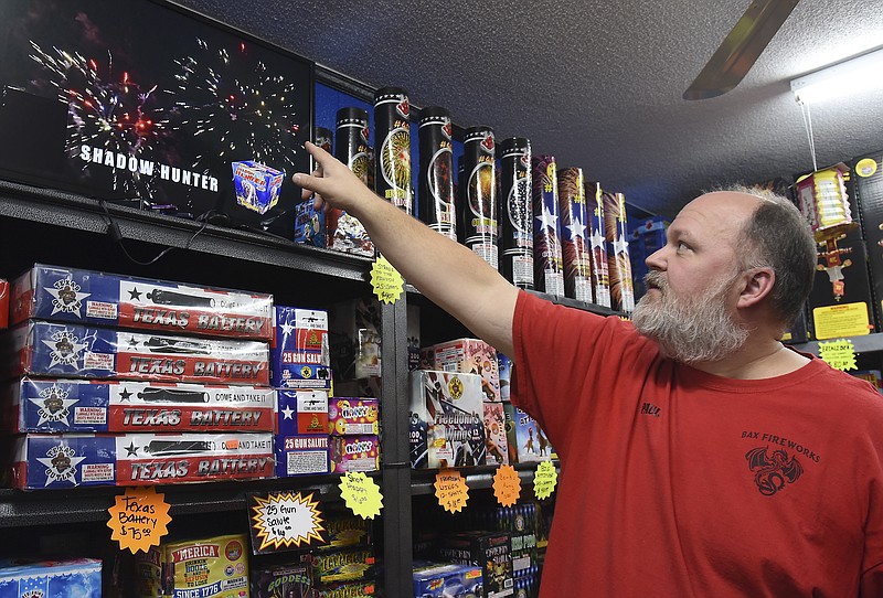 Julie Smith/News TribunePaul Bax shows a video of how a specific firework is supposed to display when fired. Bax, owner of Bax Fireworks in Brazito, used a bar code reader wand to activate the display. A person interested in purchasing a firework can use the scanner to activate the display and a picture of the packaging appears in the corner of the screen with the name clearly visible on the screen. With so many fireworks available, customers really enjoy the opportunity to get a preview of the item before making a purchase. Bax stresses safety while using any and all fireworks and added to remain sober when lighting the colorful displays and to not place anything over the firework that you aren't willing to lose. If firing traditionally handheld fireworks, purchase the extenders so they aren't in your hand. Bax reiterated "most importantly",  "read and follow the directions printed on each package." 