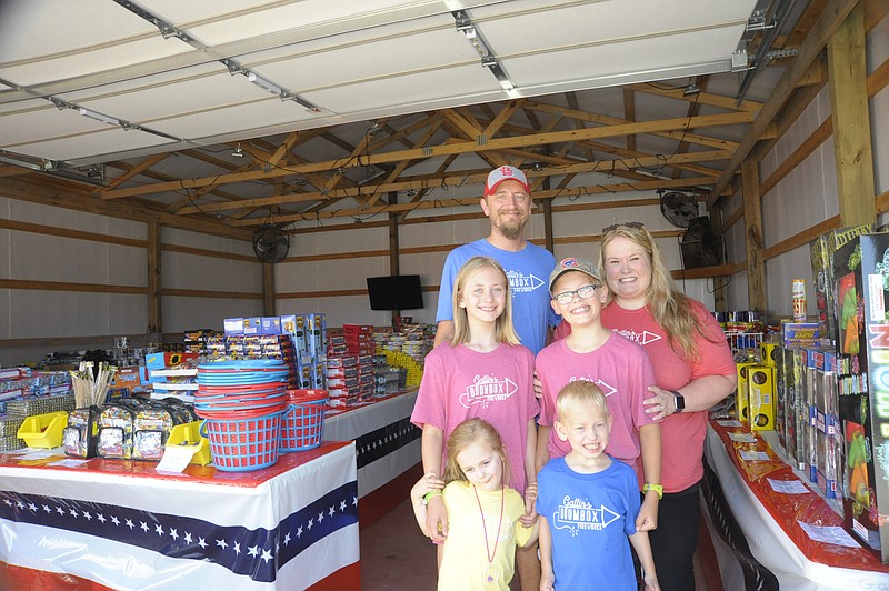 <p>Democrat photo/Danisha Hogue</p><p>The Gatlin family poses inside its firework stand near California. For five years, the family had specialized in fireworks for children.</p>