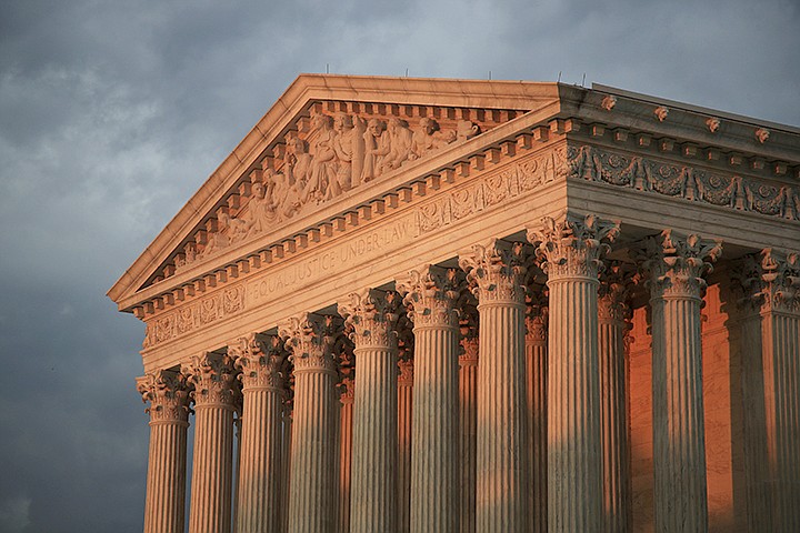 This Oct. 4, 2018, file photo shows the U.S. Supreme Court at sunset in Washington. More than 200 corporations have signed a friend-of-the-court brief urging the U.S. Supreme Court to rule that federal civil rights law bans job discrimination on the basis of sexual orientation and gender identity. The brief, announced Tuesday, July 2, 2019 by a coalition of five LGBTQ-rights groups, is being submitted to the Supreme Court this week ahead of oral arguments before the justices this fall on three cases that may determine whether gays, lesbians and transgender people are protected from discrimination by existing federal civil rights laws. (AP Photo/Manuel Balce Ceneta, File)