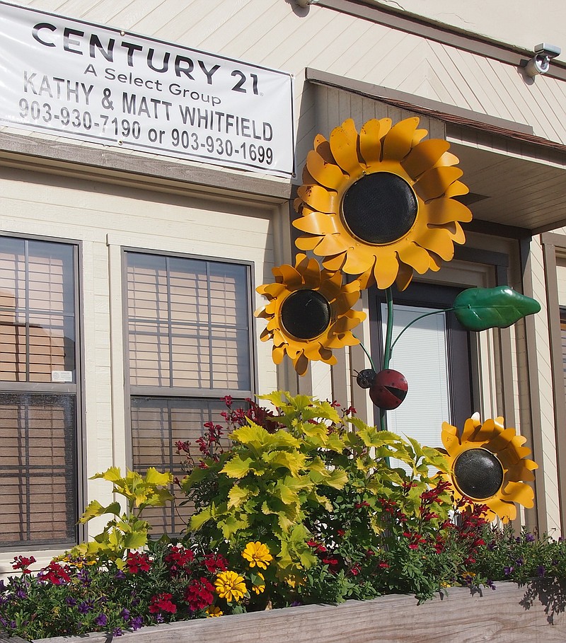 Linden Garden Club certainly keeps pretty flowers growing around courthouse square, but who knew they could grow sunflowers this big? (They are, of course, tin and are a gift of citizen Mary Dowd. The flowers in the box are real, however.)