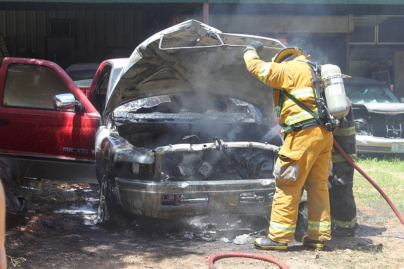 <p>A firefighter with the California Fire Department extinguishes the last flames of a truck fire July 3 just off Airport Road. The fire, which was first called in at around noon, started when the owner of the vehicle attempted to turn the ignition. The flames did not touch any other property, and no one was hurt.</p>