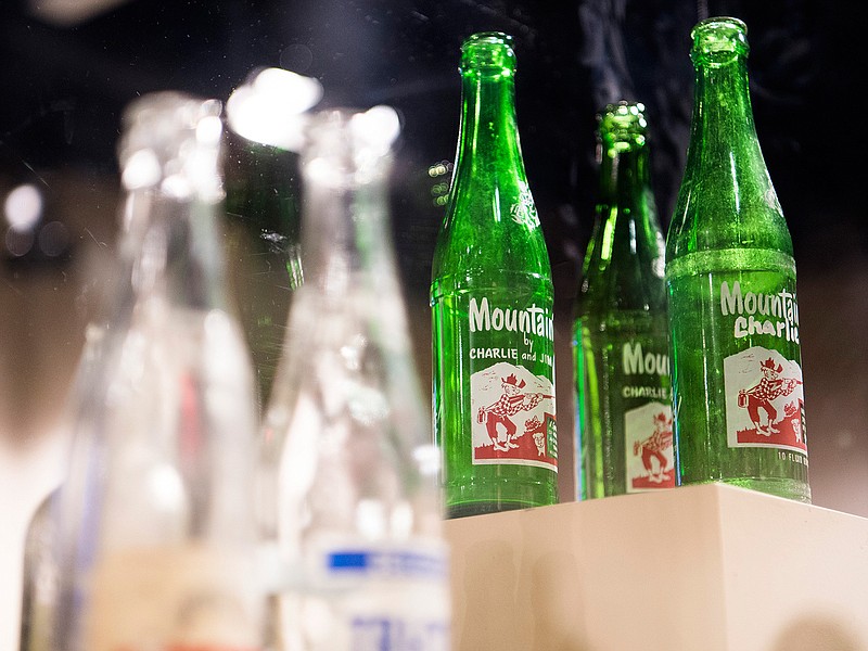 This Monday, June 24, 2019 photo shows Mountain Dew items that are on display in an exhibit dedicated to Mountain Dew and its origins in Tennessee at the Museum of East Tennessee History in Knoxville, Tenn. Mountain Dew _ now the country's third most popular soft drink _ began because two Knoxville brothers needed a tasty mixer for their bourbon. A new exhibit at the Museum of East Tennessee History, 601 S. Gay St., traces Mountain Dew's regional roots and cultural connections. "It'll Tickle Yore Innards!": A (Hillbilly) History of Mountain Dew" runs through Jan. 20. (Brianna Paciorka/Knoxville News Sentinel via AP)