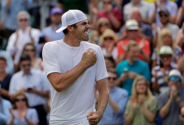 Reilly Opelka celebrates after beating Stan Wawrinka in their singles match Wednesday at Wimbledon in London.