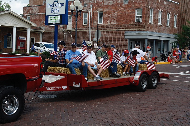 In this July 4, 2019, photo, United States military veterans ride on a trailer during the eighth annual Independence Day Parade of Callaway County at the intersection of 6th and Court streets. (Quinn Wilson/FULTON SUN photo)