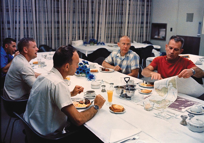 Apollo 11 astronauts Neil Armstrong, second from left, Michael Collins and Buzz Aldrin eat breakfast with Donald "Deke" Slayton, in red shirt, on launch day, July 16, 1969. (NASA/TNS)