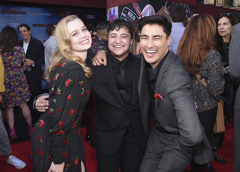 This June 26, 2019 photo released by Sony Pictures shows, from left, Angourie Rice, Zach Barack and Remy Hii at the world premiere of "Spider-Man: Far From Home" at the TCL Chinese Theatre in Los Angeles. Barack, who plays the first openly transgender actor in the Marvel Universe, says there needs to be more express representation of his experience. Superhero movies "always felt like a trans story because it's talking about identity," said Barack at last month’s premiere of "Spider-Man: Far From Home," in which he plays a classmate of Peter Parker's. His gender identity is not addressed in the movie. (Stewart Cook/Sony Pictures via AP)