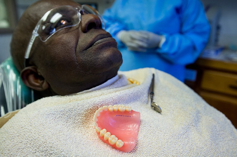 Beazley Jackson sits in the dental chair as he is fitted for new 3D printed dentures at the Goree Unit 3D Denture Clinic on Thursday, June 13, 2019, in Huntsville, Texas.  Seven months after the Texas Department of Criminal Justice announced plans to launch a start-of-the-art denture clinic, inmates from across the system are starting to get some of the first sets of 3D-printed teeth ever made inside a U.S. prison.  (Brett Coomer/Houston Chronicle via AP)