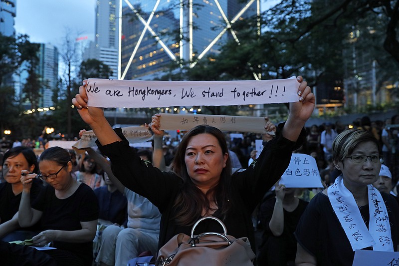 Attendees take part in a rally by mothers in Hong Kong on Friday, July 5, 2019. Hong Kong's societal divide showed no sign of closing Friday as students rebuffed an offer from city leader Carrie Lam to meet and a few thousand mothers rallied in support of young protesters who left a trail of destruction in the legislature's building at the start of the week. (AP Photo/Kin Cheung)
