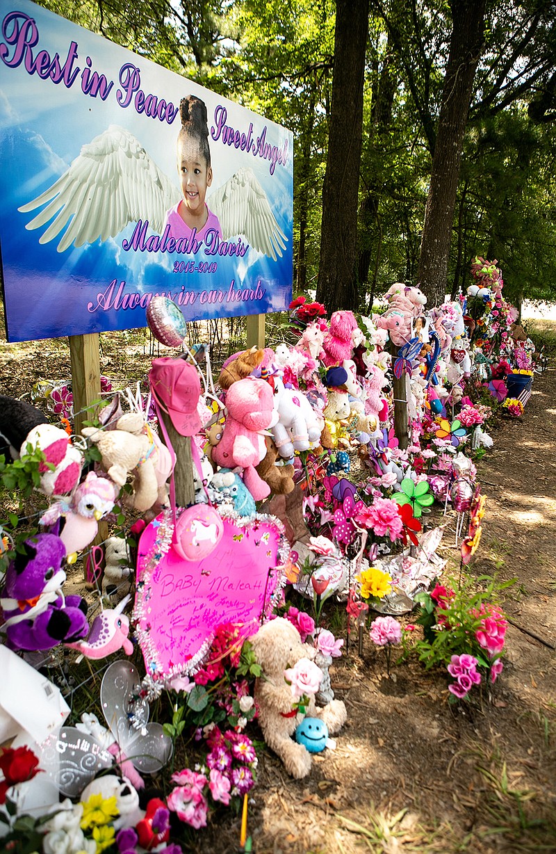 Flowers, toys, wreaths and more cover the fence Friday in memory of 4-year-old Maleah Davis at Exit 18 off Interstate 30 near Fulton, Ark. The bridge where her remains were found could possibly be renamed in her honor.