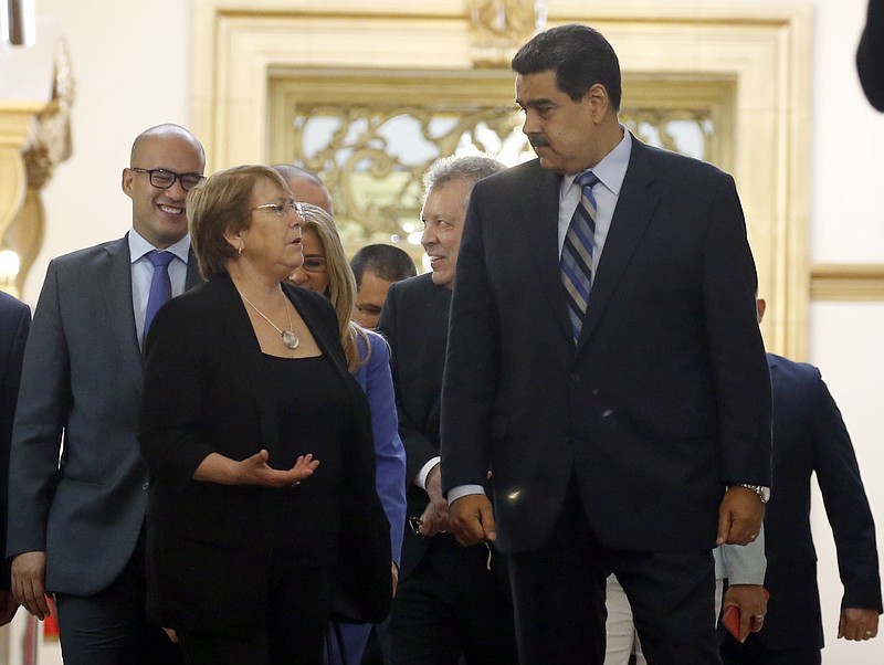 U.N. High Commissioner for Human Rights Michelle Bachelet, left, chats with Venezuela's President Nicolas Maduro, as they walk out of a meeting at Miraflores Presidential Palace, in Caracas, Venezuela, Friday, June 21, 2019. The United Nations' top human rights official is visiting Venezuela amid heightened international pressure on President Maduro. (AP Photo/Ariana Cubillos)