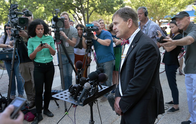 FILE -In this June 5, 2019, file photo, Dr. Randall Williams, Director of the Missouri Department of Health and Senior Services, speaks with reporters outside the courthouse after Circuit Judge Michael Stelzer heard his testimony concerning the renewal of Planned Parenthood's abortion clinic license in St. Louis.  As director of the state's Department of Health and Senior Services,  Williams oversees the agency that licenses health care facilities, tracks the spread of disease and is now setting up the state’s medical marijuana program. Each of those services has spawned disputes in Missouri, with the most recent involving the political storm surrounding the move to close the state’s Planned Parenthood clinic in St. Louis.   (Robert Cohen/St. Louis Post-Dispatch via AP, File)