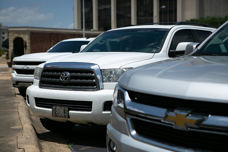 A row of parked vehicles heat up under the summer sun Friday in Texarkana. Texas leads the nation in children dying in hot cars. 