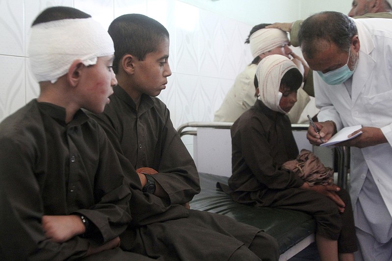 Injured boys receive treatment in a hospital after a car bomb attack in Ghazni province, central Afghanistan, Sunday, July 7, 2019. Afghan officials say a car bomb in central Afghanistan has killed a few people and wounded dozens of people, many of them students attending a nearby school. (AP Photo/Rahmatullah Nikzad)