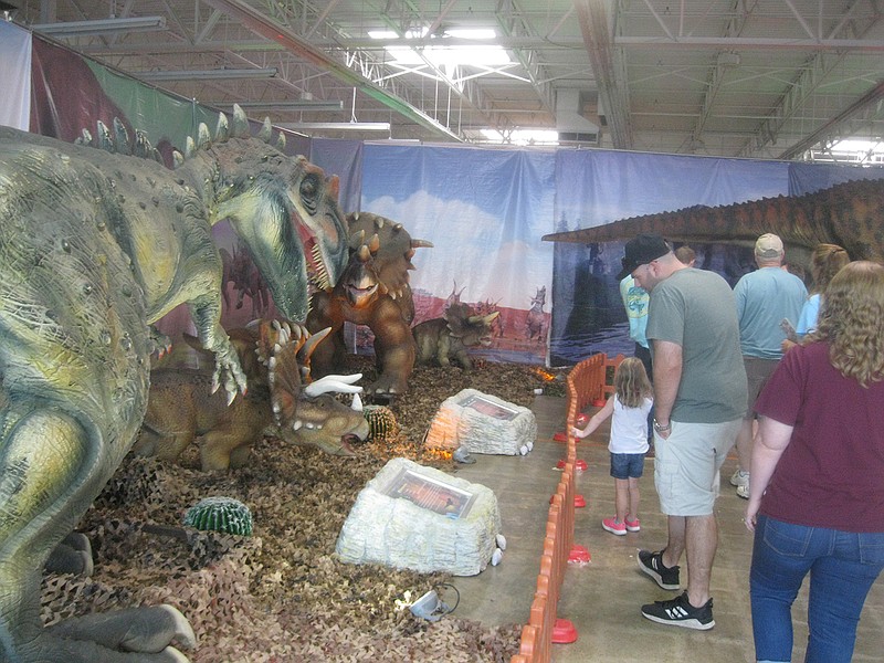 Visitors enjoy the display Sunday at the My Jurassic Adventure exhibit at the former Toys "R" Us building near Central Mall in Texarkana, Texas. An estimated 5,000 adult and 7,000 child dinosaur fans viewed the attraction over the weekend.