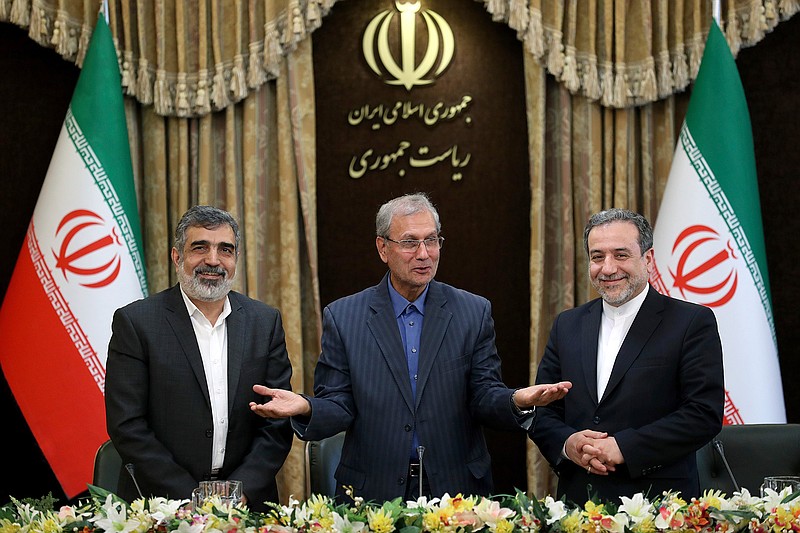 From left to right, spokesman for Iran's atomic agency Behrouz Kamalvandi, Iran's government spokesman Ali Rabiei and Iranian Deputy Foreign Minister Abbas Araghchi, attend a press briefing in Tehran, Iran, Sunday, July 7, 2019. The deputy foreign minister says that his nation considers the 2015 nuclear deal with world powers to be a "valid document" and seeks its continuation. (AP Photo/Ebrahim Noroozi)