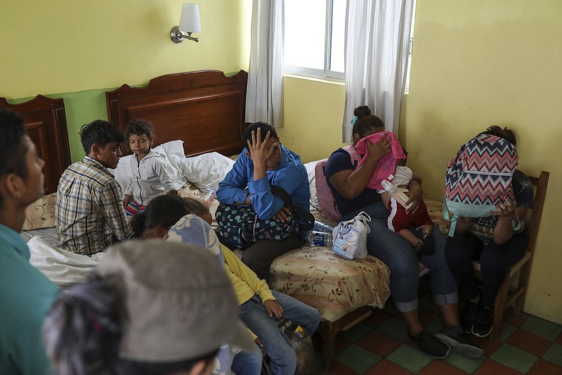 Central American migrants sit together inside a room at the Latino hotel during a raid by Mexican immigration agents in Veracruz, Mexico, Thursday, June 27, 2019. Under increasing U.S. pressure to reduce the flow of hundreds of thousands of Central Americans through Mexican territory, Mexico's government has stepped up enforcement. (AP Photo/Felix Marquez)