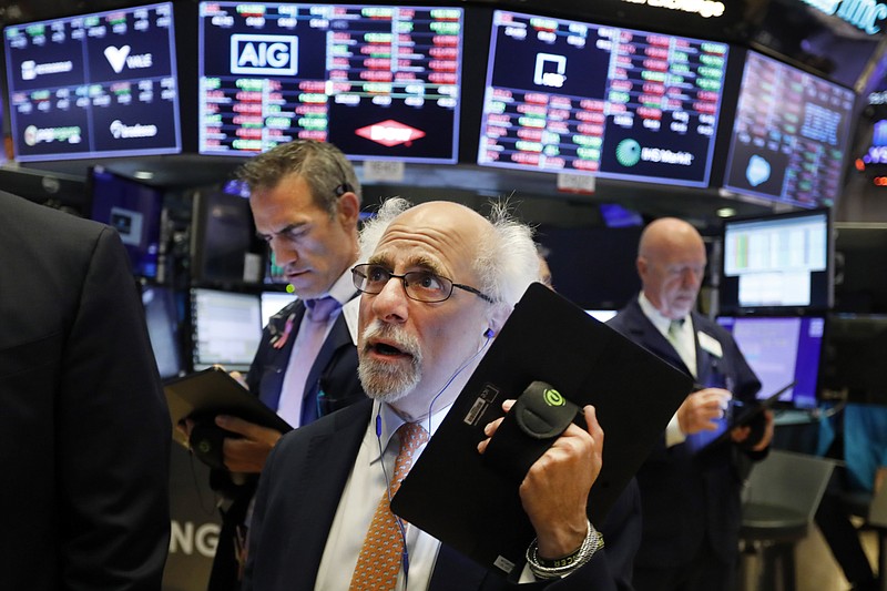 Trader Peter Tuchman works on the floor of the New York Stock Exchange, Monday, July 8, 2019. Stocks fell on Wall Street in morning trading Monday amid growing speculation among investors that unexpectedly strong U.S. employment data may keep the Federal Reserve from aggressively cutting interest rates. (AP Photo/Richard Drew)